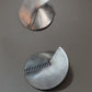 Close-up of brushed sterling silver earrings with notch and stamped lines, modern geometric handmade earrings. Boho chic, élégante and minimalist.