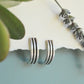 handmade semi hoops earrings in sterling silver and brass, minimalist designs and lightweight. Made by designer
