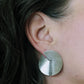 Model wearing brushed silver sterling earrings with notch and line detail.  Artisan minimalist silver jewelry.